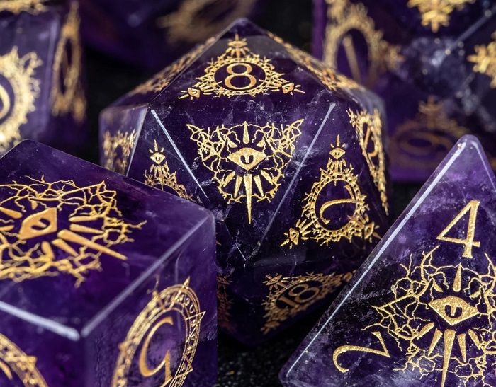 Image of purple amethyst dnd dice set with gold numbering displaying arcane-like image of eyes looking through portals
