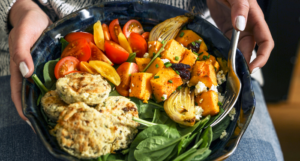 a photo of a bowl of Thankgiving food, mostly veggies